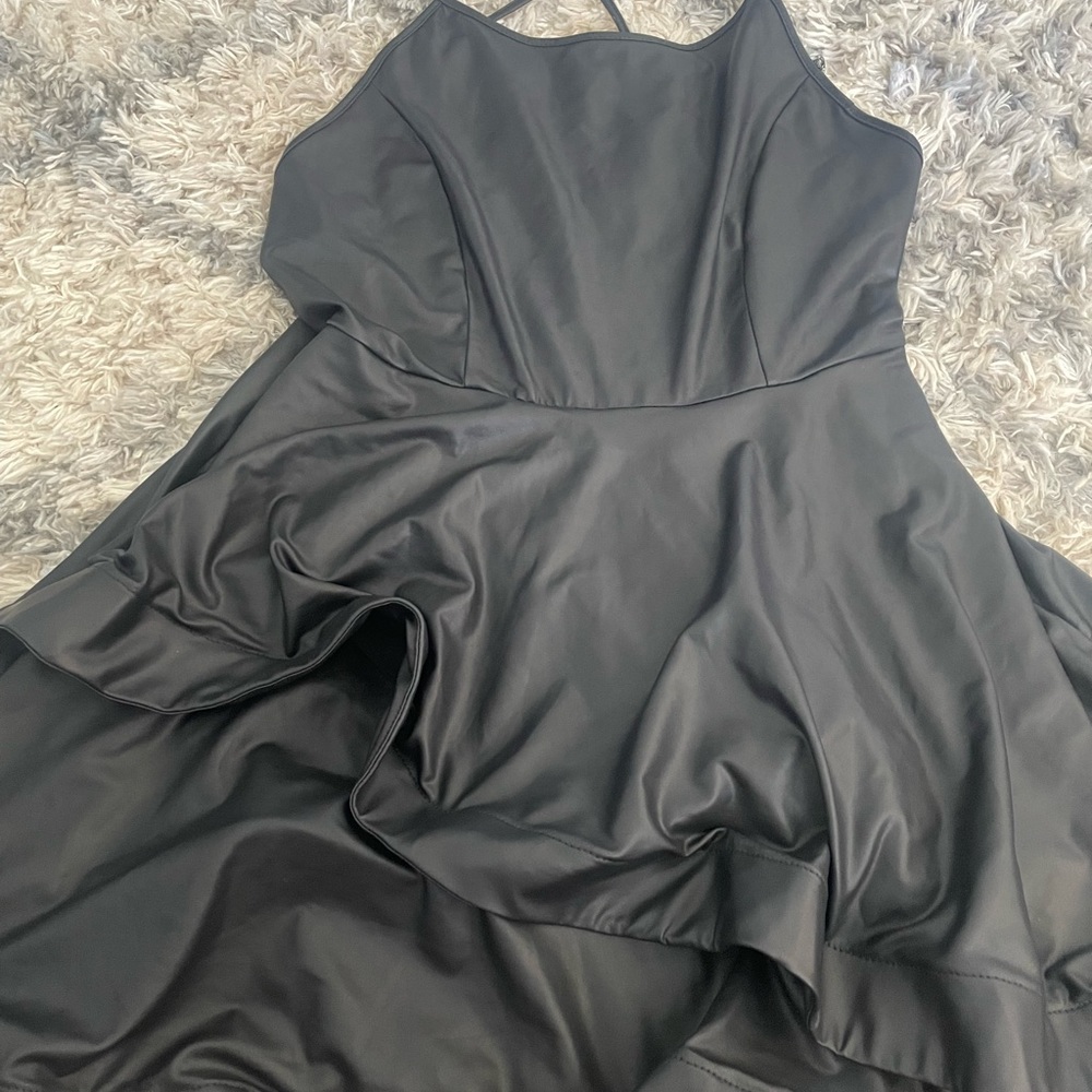 Black leather dress with ruffled bottom.